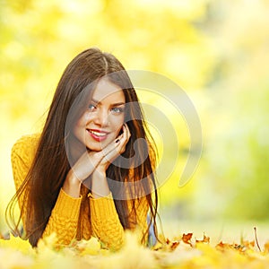 Girl laying on autumn leafs