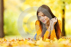 Girl laying on autumn leafs