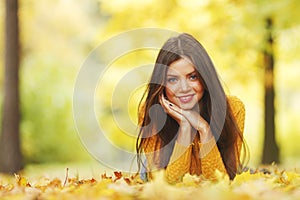 Girl laying on autumn leafs