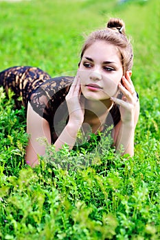 Girl laying in bright green grass