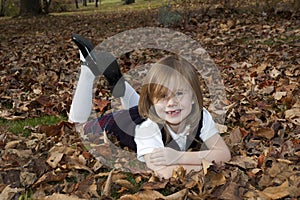 girl laying in leaves