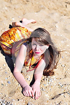 Girl laying on the sand