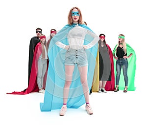 Girl leader in superhero Cape standing in front of super team.