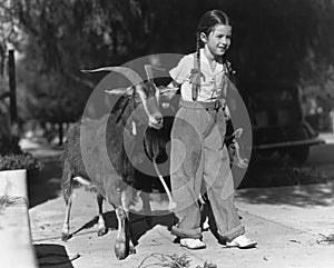 Girl leading two goats