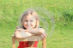 Girl leaning on chair