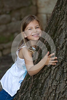 Girl leaning on oak tree