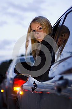 Girl leaning out car window