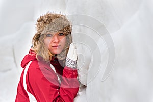 Girl leaning on snow wall