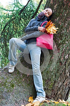 Girl leaning on tree