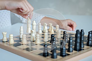 A girl learn how to play chess game