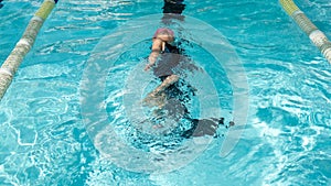 A girl learn how to swim in swimming class