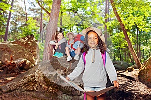 Girl learn orientation in forest on summer holiday photo