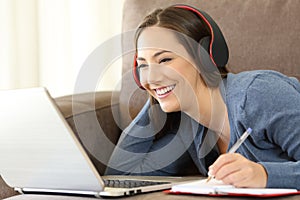 Girl learning on line listening audio tutorials