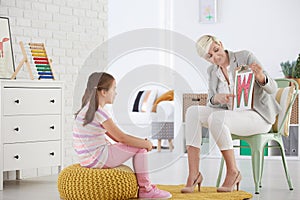 Girl learning reading difficult letters