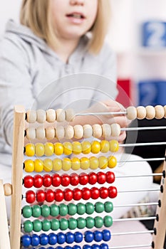 Girl learning to count using abacus