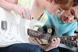 Girl learning to play guitar