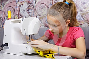 Girl learns to sew