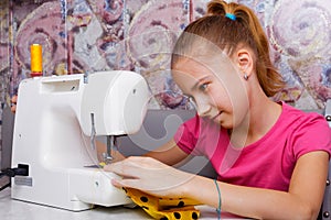 Girl learns to sew