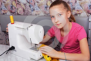 Girl learns to sew on an sewing machine