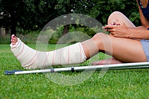 Girl with leg in plaster chatting