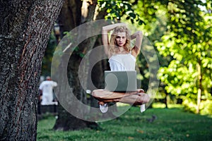 Girl levitates with laptop