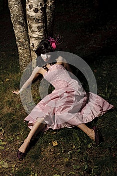 Girl lie near tree