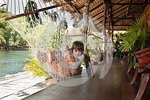 Girl lies in hammock