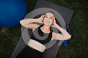 The girl lies with her eyes closed, on a yoga mat, rest after training, appeasement, meditation, karemat on the background of