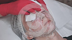The girl lies in a plastic wrap. Hydrogenation process of the facial skin.