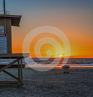 girl on a lifeguard tower in Newport Beach at sunset