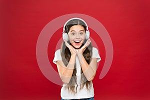 Girl listen music headphones on red background. Play list concept. Music taste. Music plays an important part lives