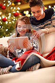 Girl listening music and enjoy with brother for Christmas eve