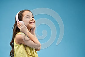 Girl listening music in headphones on isolated background
