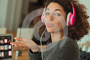 girl listening music and sending a kiss