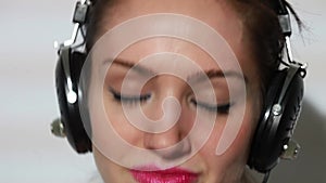 Girl listening to music and dancing closeup