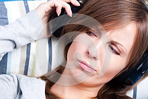 Girl listening to music with displeasure