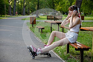 Girl listening to music on headphones in the park