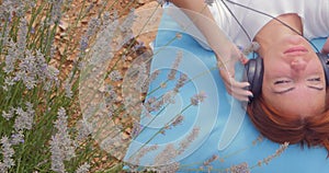 Girl listening to music with headphones in summer