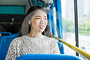 Girl listening to music on a public bus