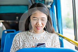 Girl listening to music on a public bus