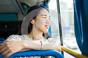 Girl listening to music on a public bus