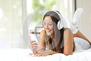 Girl listening to music from a smartphone at home