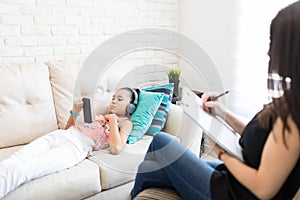 Girl Listening To Music To Neglect Psychologist At Home
