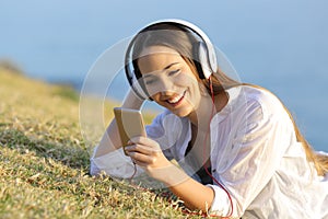 Girl listening to music watching smart phone content