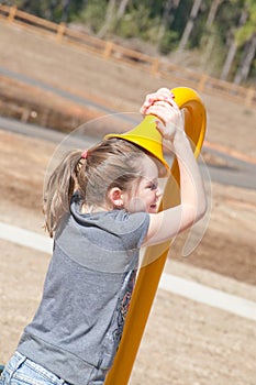 Girl listening to playground phone