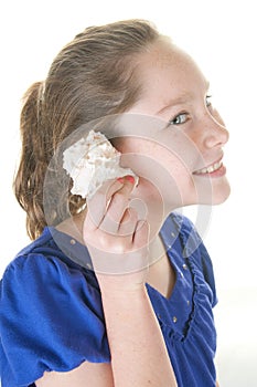 Girl listening to seashell