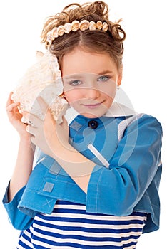 Girl listening to sounds of sea in cockle-shell