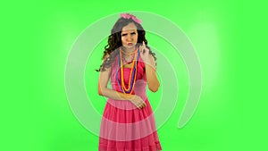 Girl listens carefully, threatens with a finger and waves her head. Green screen