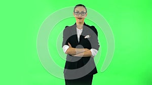 Girl listens carefully, threatens with a finger and waves her head negatively. Green screen