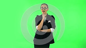 Girl listens carefully, threatens with a finger and waves her head seductively. Green screen